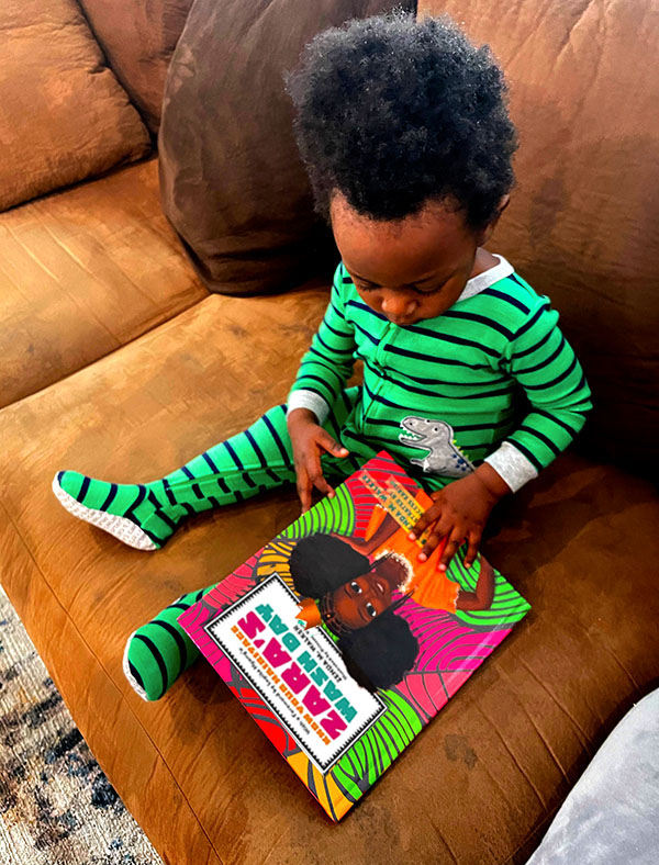 Baby Boy reading Zara's Wash Day in Green Jumper photo