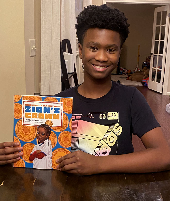 African American boy at a table while reading Zion's Crown photo